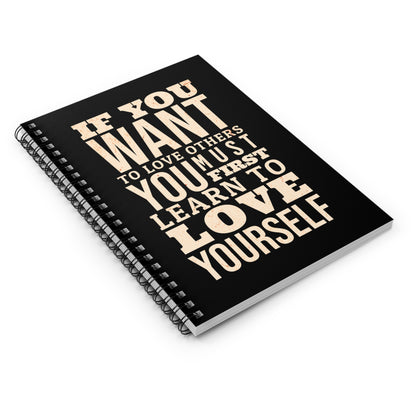 Black notebook with motivational quote on a white background