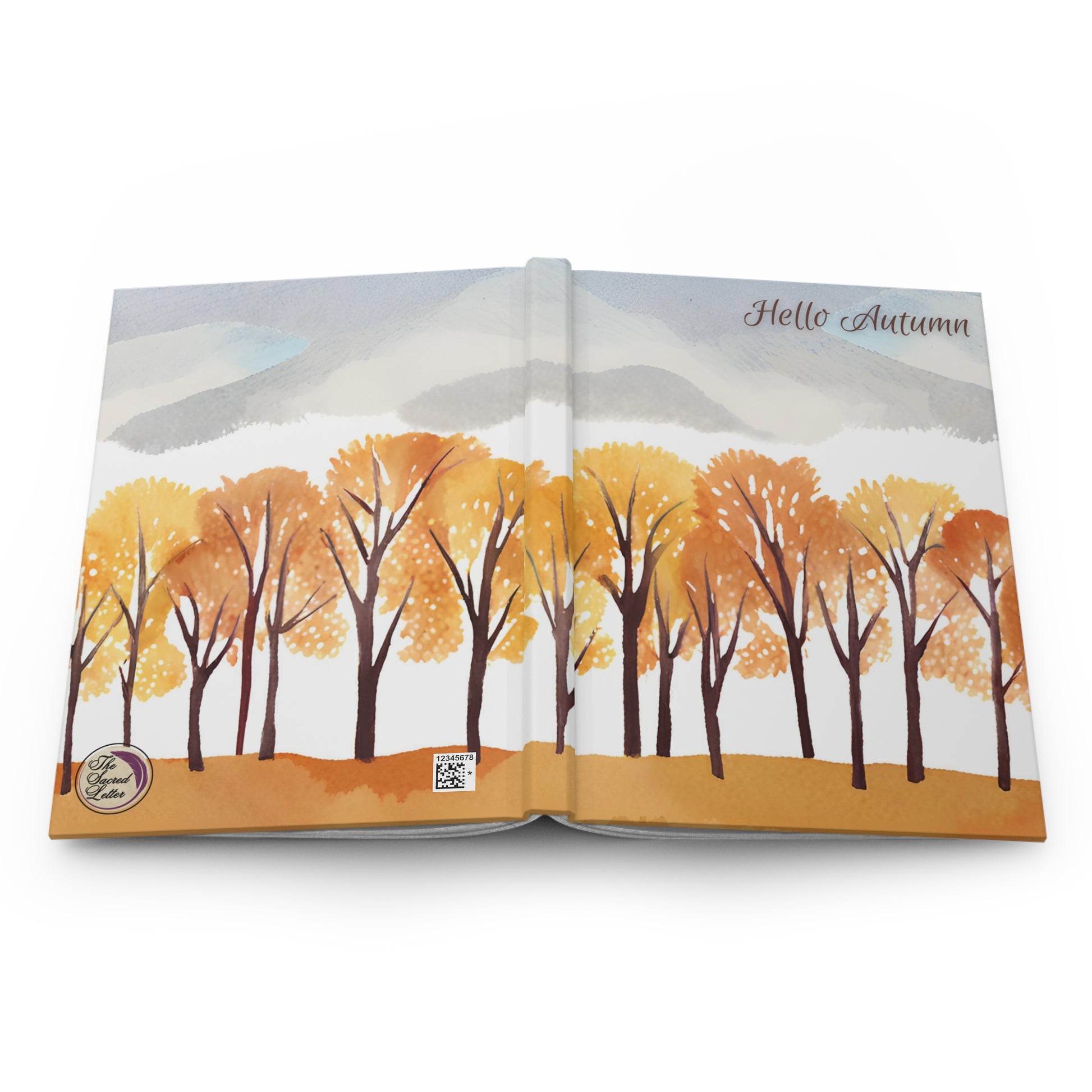 Open book with autumn-themed illustration of trees and mountains on a white background