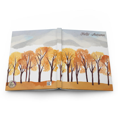 Open book with autumn-themed illustration of trees and mountains on a white background