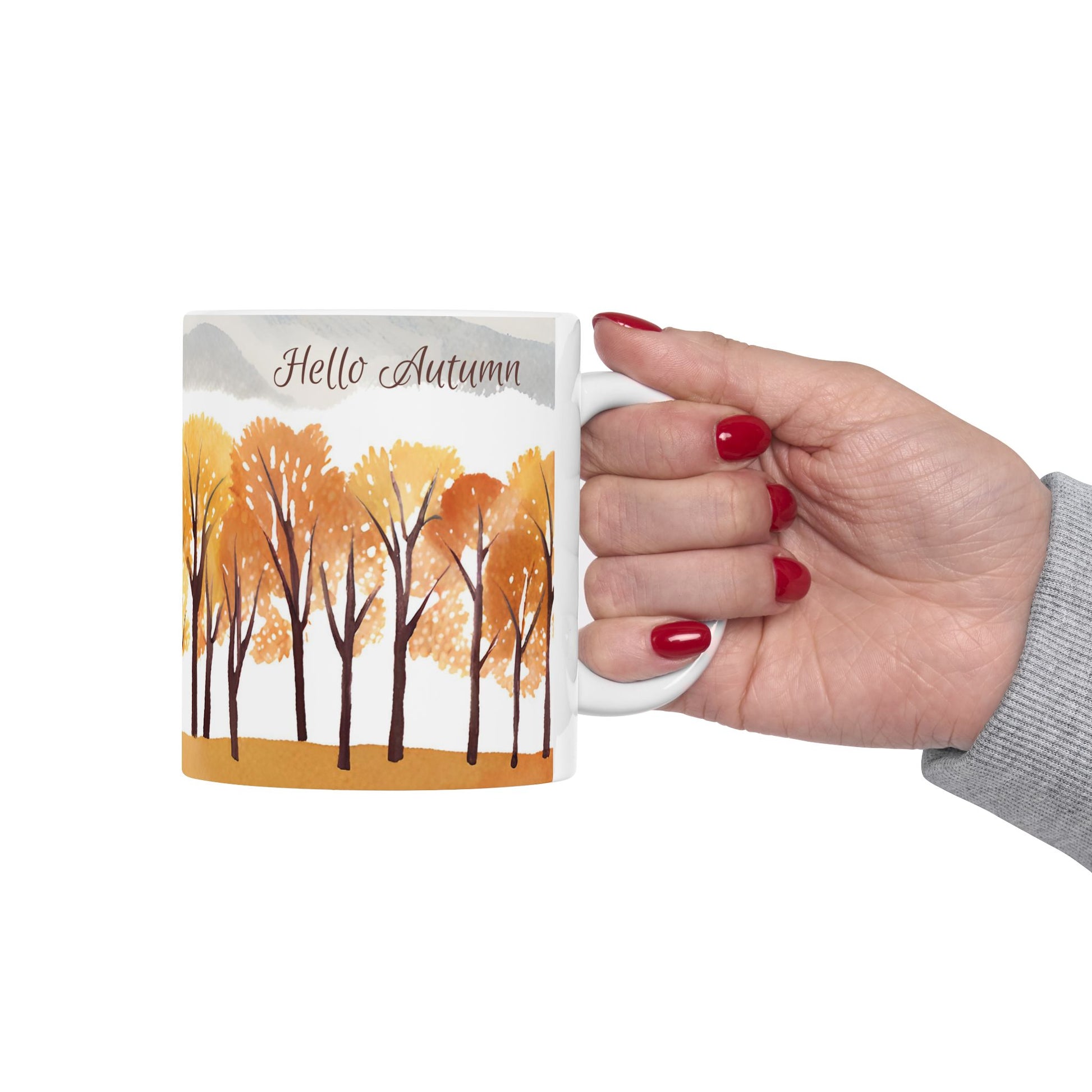 Hand holding a mug with 'Hello Autumn' design on a white background