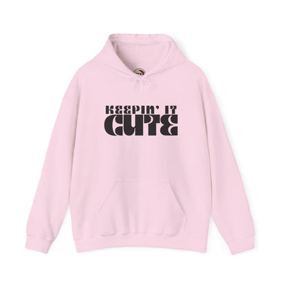 Pink hoodie with 'KEEPIN' IT CUTE' text on a white background