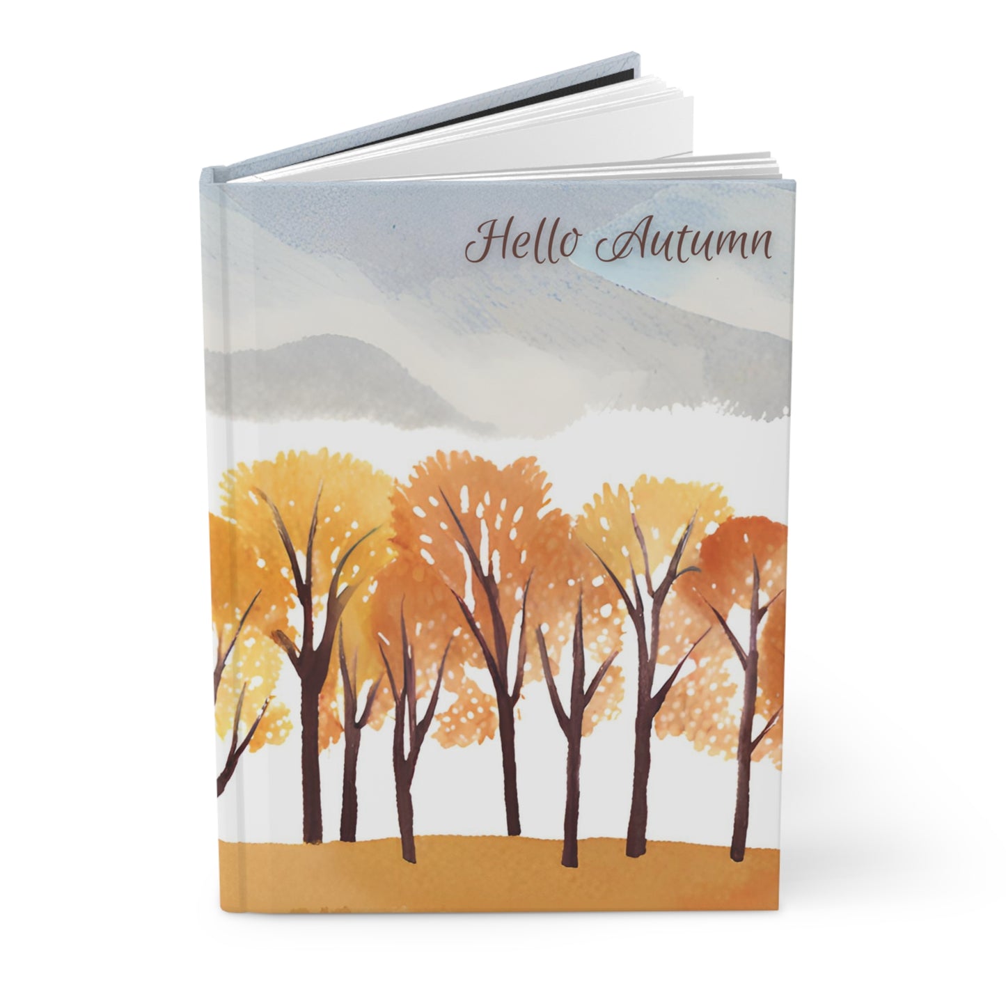 Notebook with autumn design featuring trees and mountains on a white background