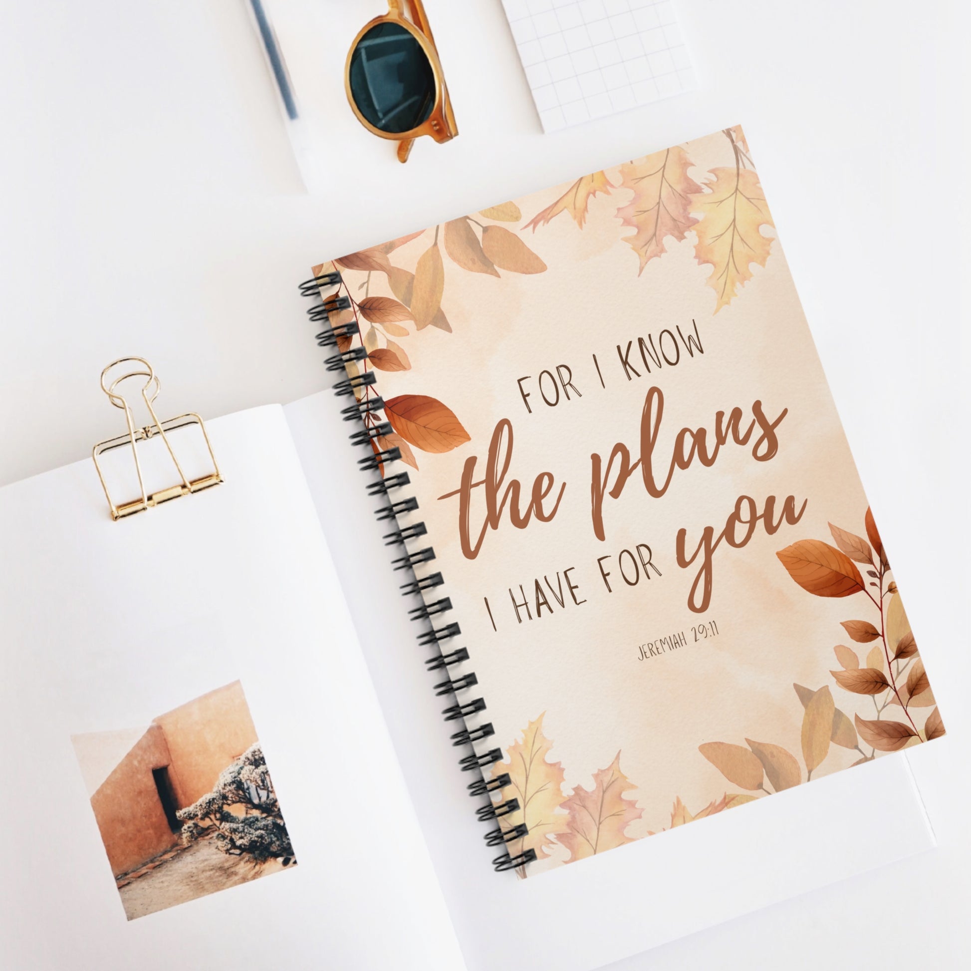 Notebook with floral design and text on a white surface