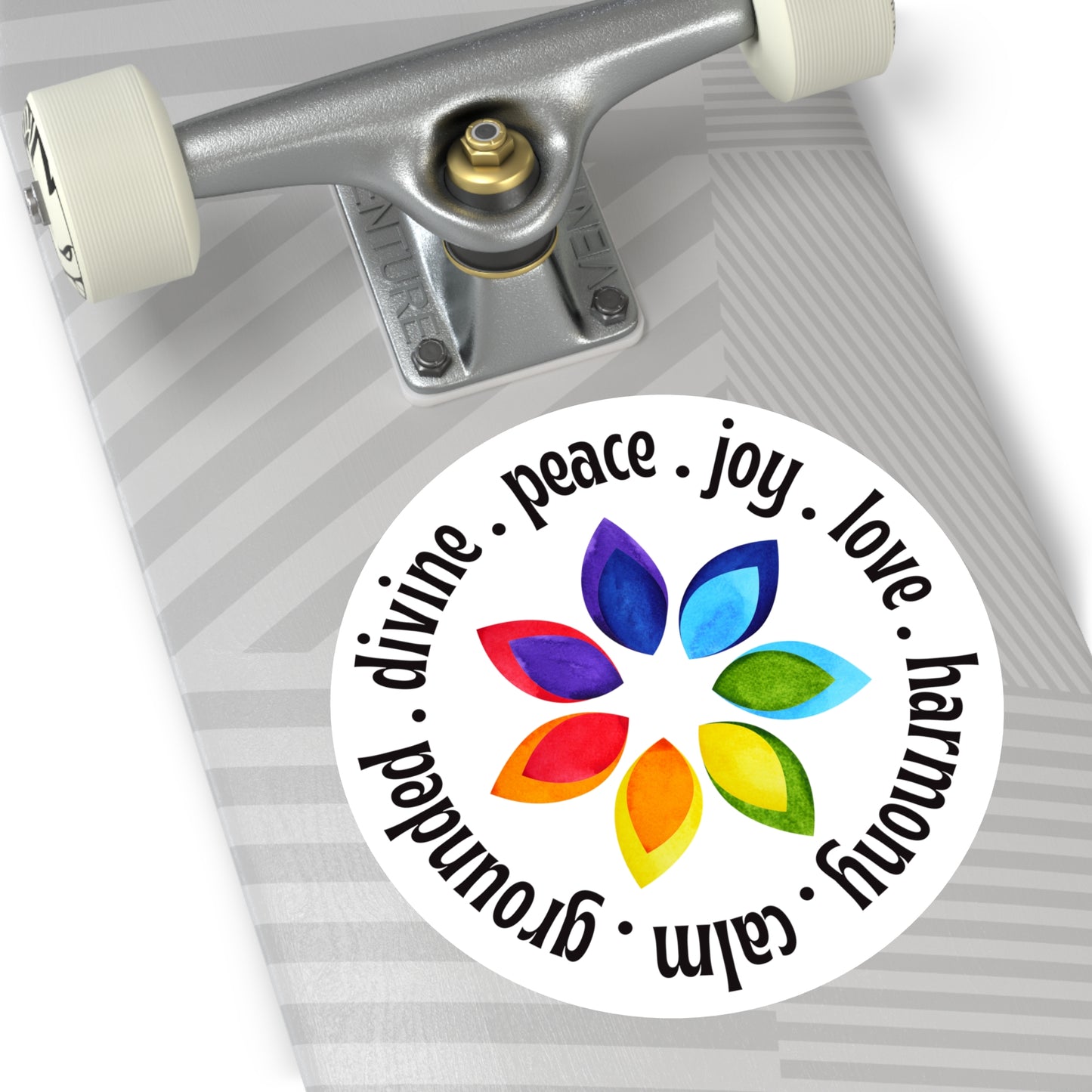Skateboard with a colorful sticker featuring leaves and text on a white background