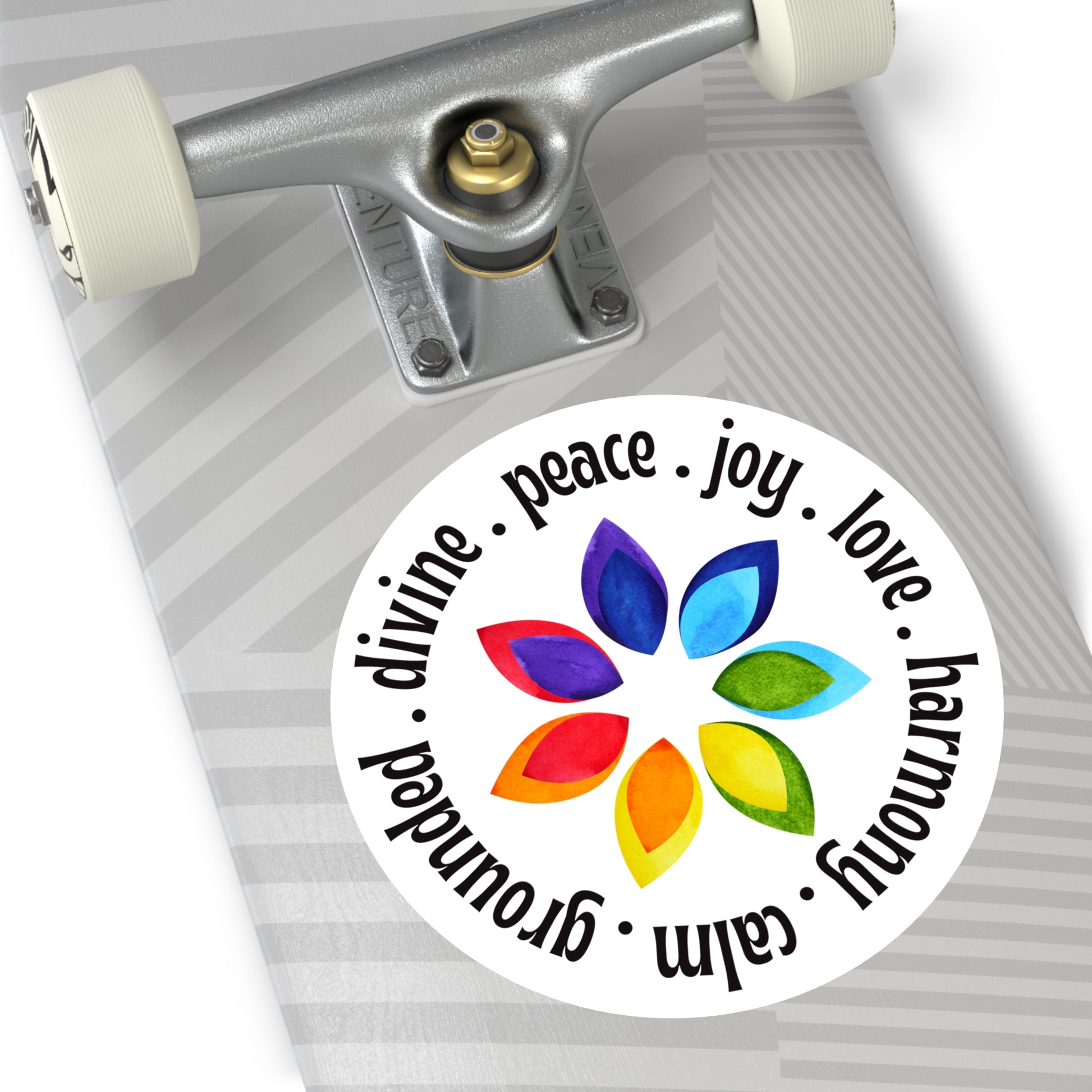 Skateboard with a colorful sticker featuring leaves and text on a white background