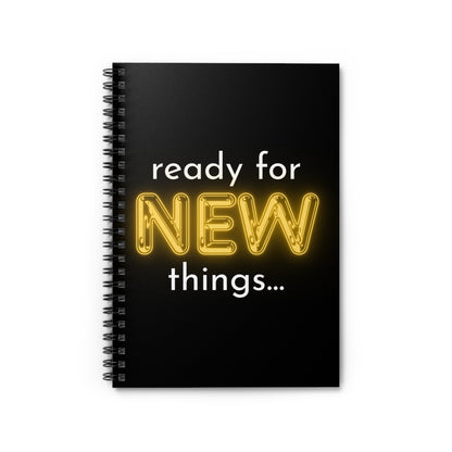 Black spiral-bound notebook with 'ready for NEW things...' text on a white background