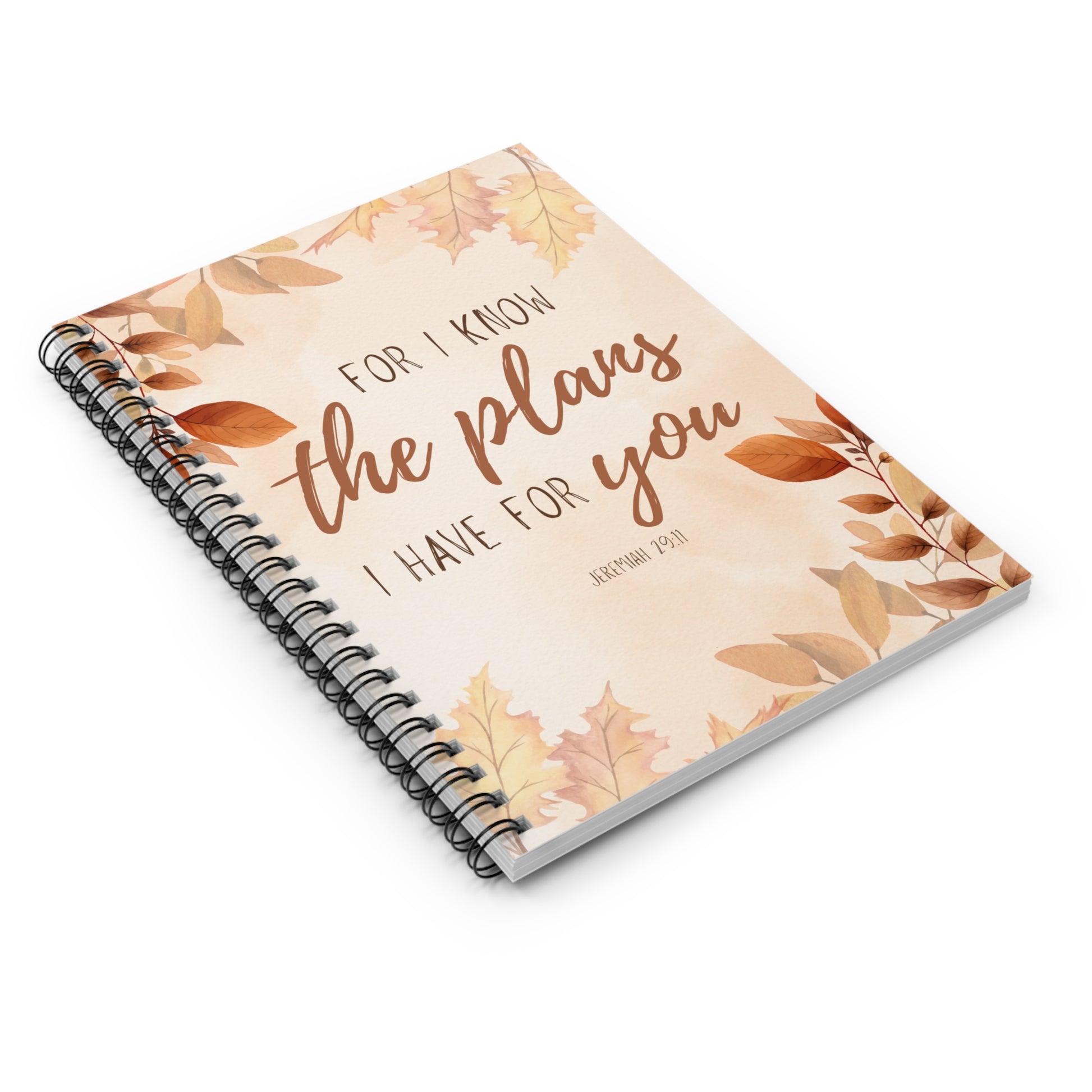 Notebook with autumn leaf design and motivational quote on a white background