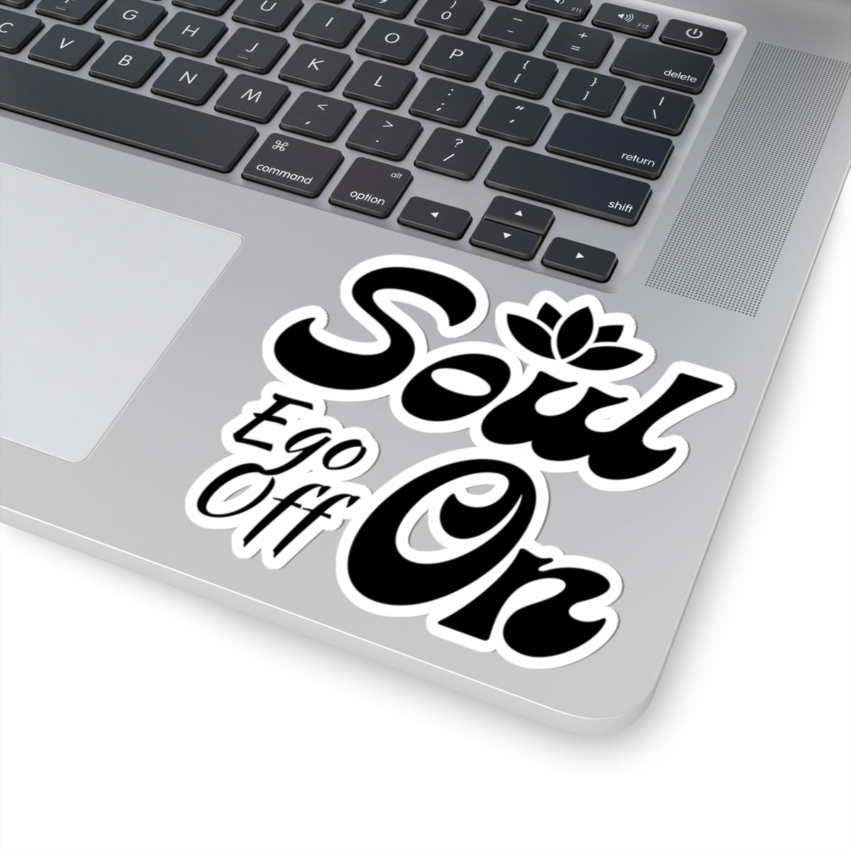 Laptop with a 'Soul Ego Off On' sticker on the palm rest area