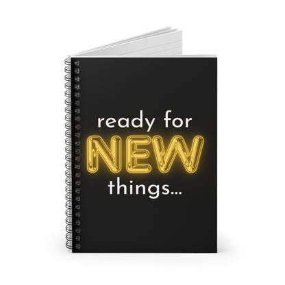 Black notebook with 'ready for NEW things...' text on a white background