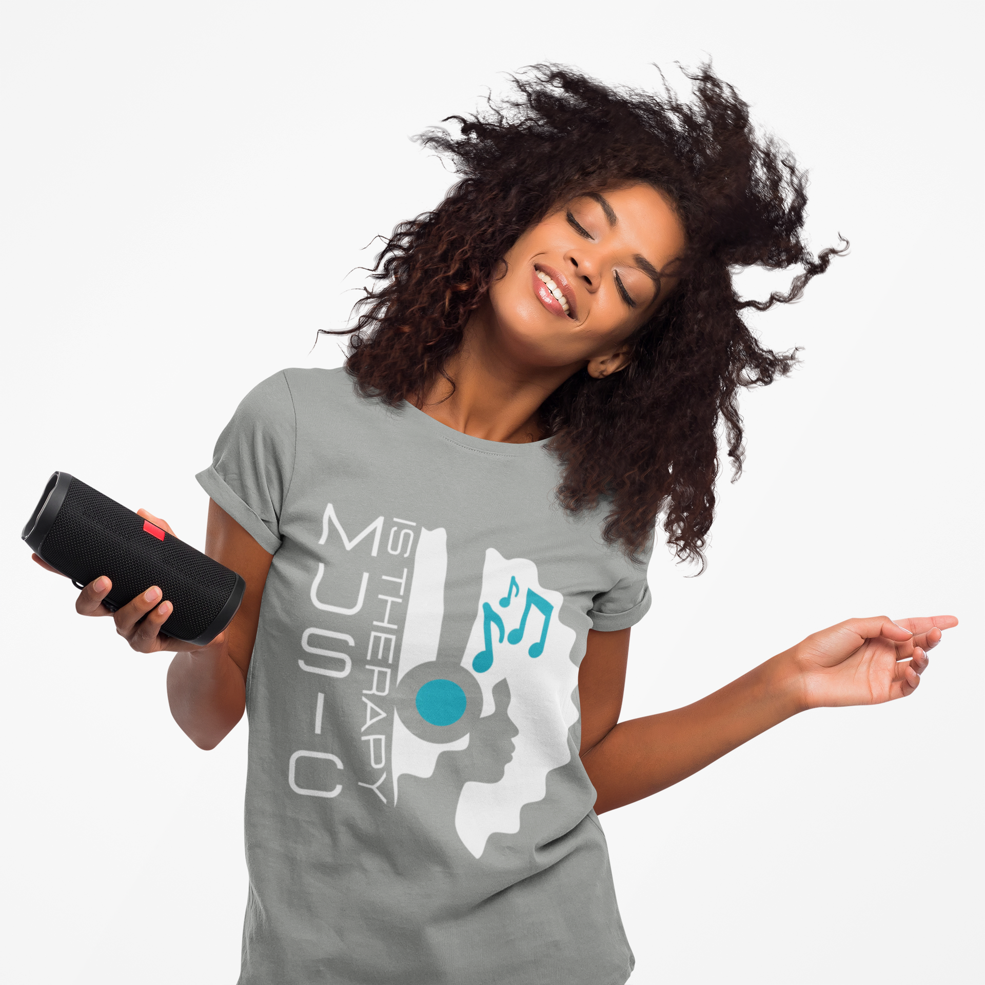 Woman wearing a gray t-shirt with a music-themed design, holding a black speaker.
