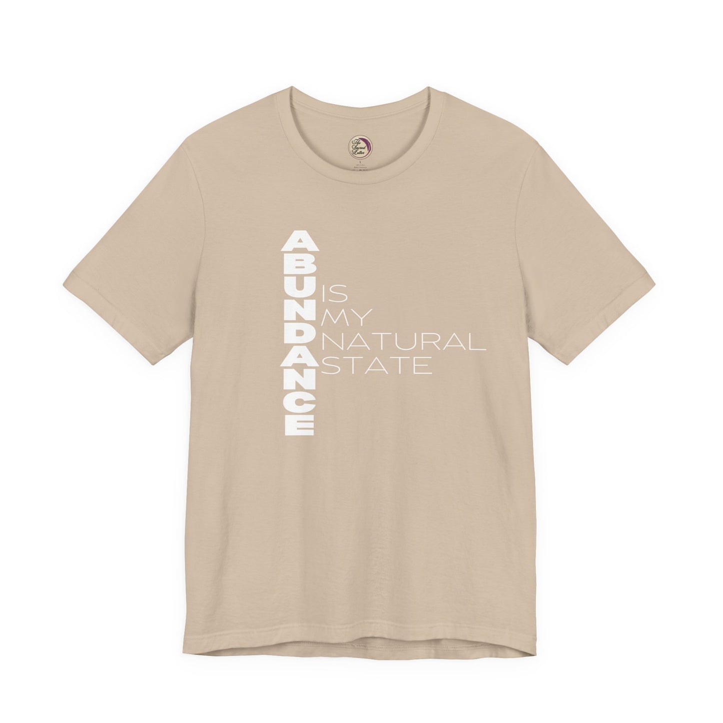 Beige t-shirt with 'ABUNDANCE IS MY NATURAL STATE' text on a white background