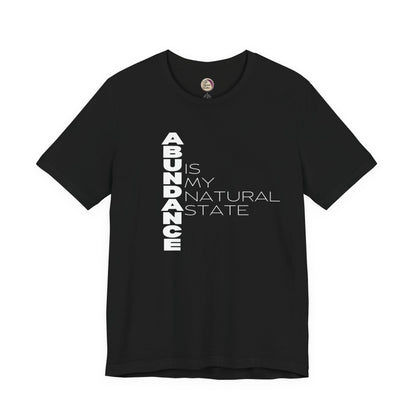 Black t-shirt with 'ABUNDANCE IS MY NATURAL STATE' text on a white background