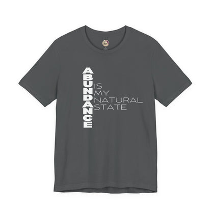 Gray t-shirt with motivational text 'ABUNDANCE IS MY NATURAL STATE' on a white background