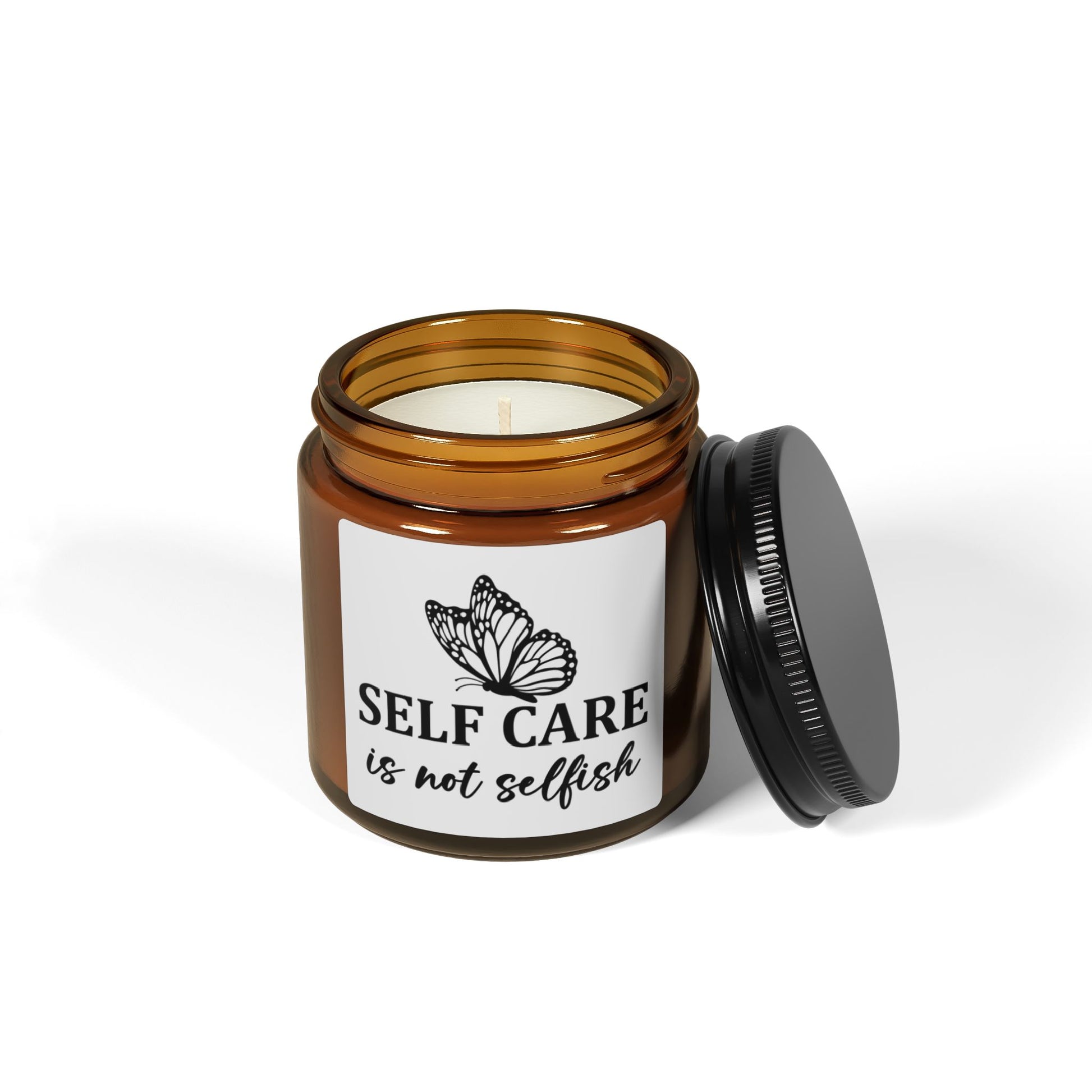 Candle in an amber jar with a label reading 'Self care is not selfish' on a white background