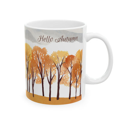 White mug with autumn-themed design featuring trees and 'Hello Autumn' text on a white background