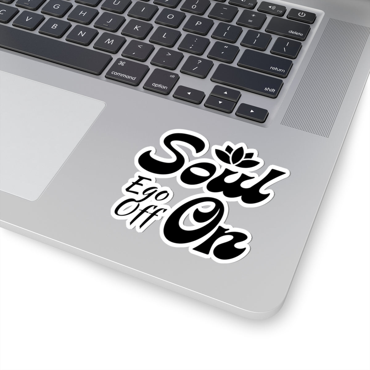 Laptop with a 'Soul Ego Off On' sticker on the palm rest area