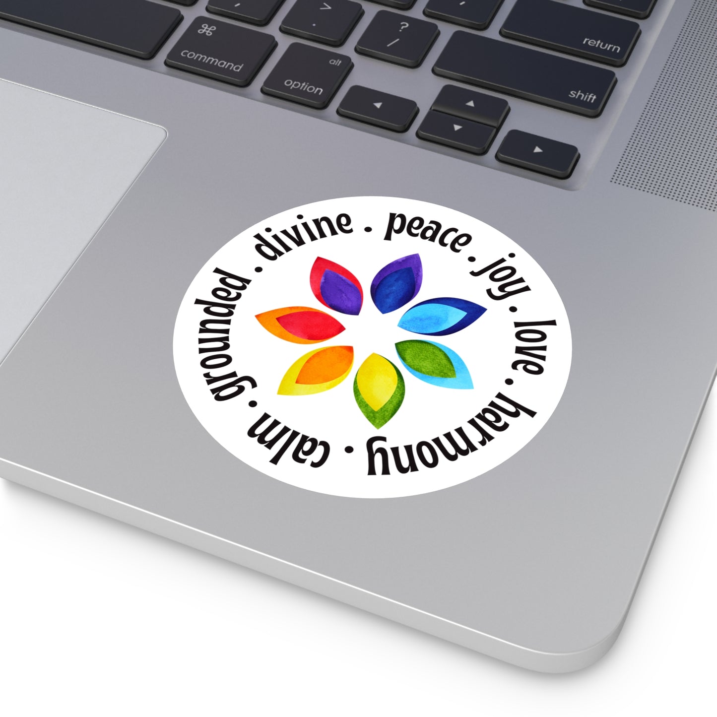 Colorful sticker with a flower design and text on a laptop